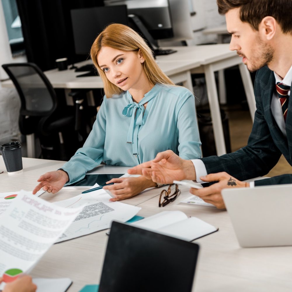 business colleagues discussing work during meeting in office