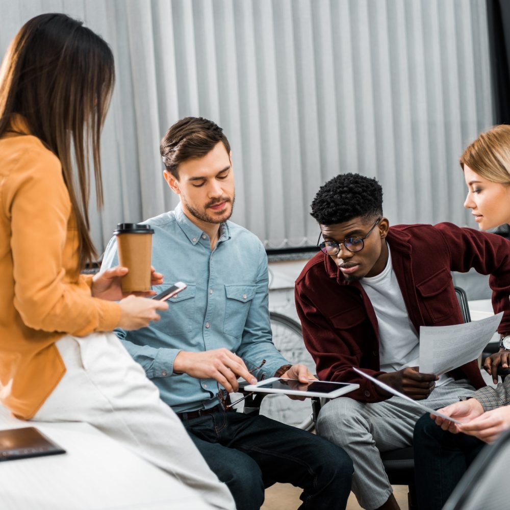 multicultural young businesspeople discussing new business idea in office